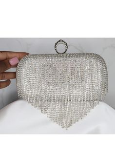 Introducing our glamorous Shiny Diamond Fringed Evening Hand BagShiny Diamond Fringed Evening Hand Bag, a captivating accessory that will instantly elevate your evening ensemble to new heights of sophistication. This exquisite handbag is designed to make a statement and create an aura of luxury that is sure to turn heads wherever you go. The handbag features a sleek and compact design, perfectly sized to hold your essentials while exuding elegance. The exterior is adorned with shimmering diamond Glamorous Handheld Evening Bag For Events, Glamorous Wedding Evening Bag With Detachable Handle, Glamorous Evening Bag With Rhinestone Fringe For Party, Glamorous Party Evening Bag With Detachable Handle, Silver Evening Bag With Detachable Handle For Wedding, Glamorous Clutch With Detachable Handle For Events, Silver Bags With Rhinestone Fringe For Formal Occasions, Glamorous Handheld Bag For Prom, Elegant Party Evening Bag With Rhinestone Fringe