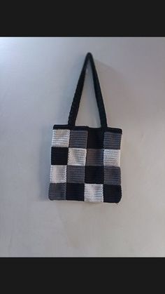 a black and white purse hanging on the wall