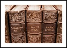 several books are stacked on top of each other with the words history of magic written on them