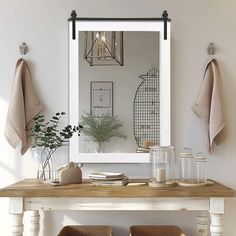 a table with two chairs and a mirror