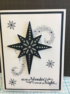 a handmade christmas card with a black and white star