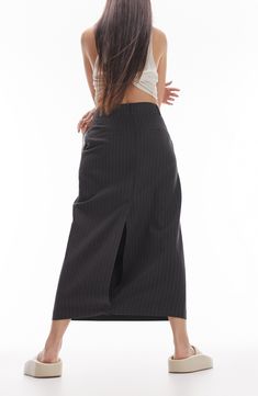 Rock a chic grey maxi skirt with cool pinstripe accents. Crafted from breezy polyester and viscose, it's comfy, easy to care for and gives a luxe vibe. This skirt is perfect for any adventure! 35" length (size ts-8) Back vent 97% polyester, 3% viscose Machine wash, line dry Imported Grey Maxi Skirt, Grey Maxi Skirts, Grey Maxi, Garment Labels, Rock A, Wardrobe Basics, British Design, Office Wear, Global Fashion