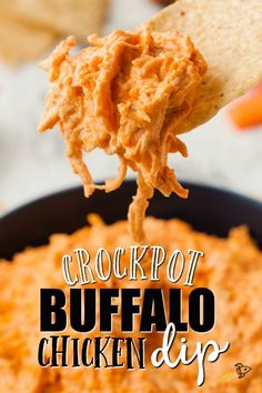 a spoon full of chicken dip being held by a tortilla chip with the words crockpot buffalo dip on it