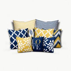 four pillows with different designs on them, one is blue and the other is yellow