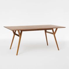 a wooden table sitting on top of a white floor