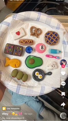 a paper plate filled with different types of food on top of a table next to an oven