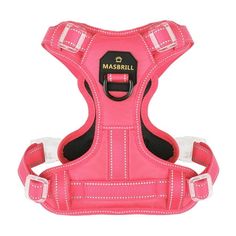 a pink dog harness with white stitching on the chest and collar, in front of a