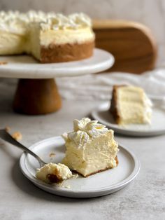 a slice of cheesecake on a plate with a fork next to the rest of the cake