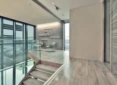 an empty room with glass walls and stairs