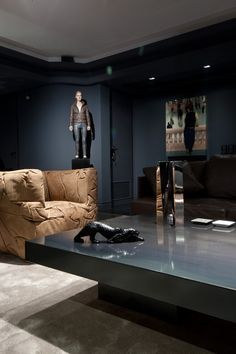 a living room filled with furniture and a statue