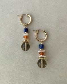 Unique gemstone hoops with removable charms. These earrings feature gorgeous smoky quartz, lapis lazuli, and coral beads.  Hoops are high quality 14kt gold filled. Gold filled is the closest to pure gold and perfect for someone who has allergies to costume jewelry. Most people will not react to gold-filled jewelry. If cared for properly these earrings can last 10 - 20 years.  Hoops measure approximately 18mm in diameter and are 3mm thick. Charms measure approximately 1.5". Total length of earrin Modern Pearl Jewelry, Beaded Charms, Vintage Gold Earrings, Gold Pearl Necklace, Gold Filled Earrings, Demi Fine Jewelry, Gold Bracelet Chain, Coral Beads, Unique Gemstones