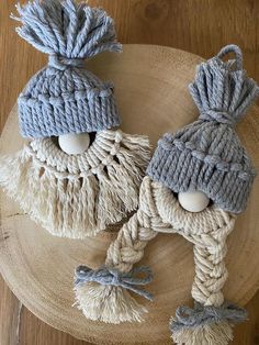 two knitted gnomes sitting on top of a wooden table