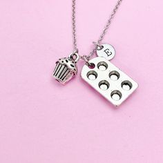 This is a silver-tone baking pan and cupcake charm with hand stamped initial charm on necklace/bracelet/keychain. ♥ You will receive one necklace/bracelet/keychain. HOW TO ORDER 1) Choose the quantity. 2) Choose the initial and style in the option or add a note to seller at checkout. 3) Add to the cart. DESCRIPTION ♥ Necklace, Stainless Steel Chain with Lobster Claw Clasp, Size: about 16-18 inches long, 1-2mm wide, Nickel Safe, OR ♥ Bracelet Chain, 304 Stainless Steel Chain, fit 6.5" to 9" wrist Nickel-free Silver Charm Necklace For Birthday, Silver Metal Charm Necklace For Birthday, Silver Hypoallergenic Charm Necklace For Birthday, Cupcake Necklace, Wax Cord Bracelet, Cupcake Charms, Bracelet Keychain, Silver Keychain, Bracelet Chain