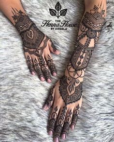 two hands with henna tattoos on them