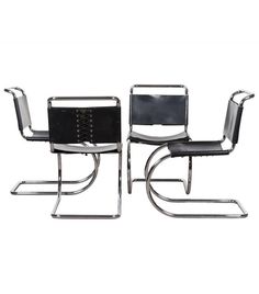 a pair of black leather and chrome chairs