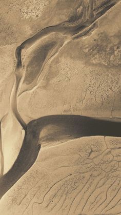 an aerial view of a river running through the desert