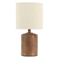 a brown table lamp with a white shade