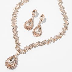 This jewelry set comes with a beautiful shimmery V-neck necklace and matching 1" drop earrings that both have a rose gold-tone finish and clear glass rhinesones. Wear this set to your next special occasion for a glammed up look. Pack Size: 2 Finish: Rose gold-tone Necklace Length: 16" + 3" extender Necklace Closure: Lobster clasp Earring Drop: 1" Earring Closure: Post back Material: Metal - Claire's Rose Gold Crystal Teardrop V-Neck Jewelry Set - 2 Pack Rose Gold Jewelry Set, Prom Necklaces, Rose Gold Crystal, Gold Jewelry Sets, Fashionable Jewelry, Neck Jewellery, Gold Crystal, Jewellery Set, Gold Tone Necklace