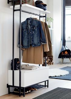 a coat rack with clothes and shoes on it