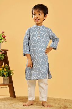 This is a traditional kurta for the boys. It is made from 100% pure cotton, has a Chinese collar and long sleeves in a pretty colour with traditional prints throughout. Composition: 100% cotton cambric Features Grey Blue colour Geometric print Coconut buttons Mandarin collar Relaxed fit Regular full sleeves Wash care : Hand wash separately in cold water. Use mild detergent. Dry in shade. Blue Cotton Traditional Wear For Eid, Fitted Blue Cotton Traditional Wear, Traditional Blue Cotton Kurta, Light Blue Cotton Traditional Wear For Eid, Blue Cotton Traditional Wear For Diwali, Blue Cotton Traditional Wear For Festivals, Light Blue Cotton Traditional Wear For Festivals, Eid Light Blue Cotton Traditional Wear, Casual Cotton Traditional Wear For Diwali