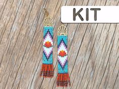 a pair of beaded earrings sitting on top of a wooden table