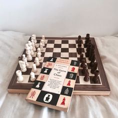 a chess board and game pieces on a bed