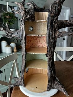 a wooden shelf with several shelves on top of it in the shape of a tree