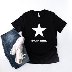 This Star Girl Tee is simple yet effortlessly cool, which makes the perfect trendy summer shirt for anyone. The material feels soft and lightweight, with its relaxed fit that is suitable for all.  About:  * 100% combed and ring-spun cotton (Heather colors contain polyester) * Fabric weight: 4.2 oz/yd² (142 g/m²) * Pre-shrunk fabric * Side-seamed construction * Shoulder-to-shoulder taping Thank you for visiting HonecloverdesignsCo! We provide all kinds of Designs and print them on shirts for you Summer Cotton T-shirt With Star Patch, Trendy Summer T-shirt With Star Patch, Casual Black Top With Star Patch, Graphic Tee With Star Logo For Summer, Casual Summer Tops With Star Logo, Casual Summer T-shirt With Star Logo, Trendy Black Top With Star Patch, Black Cotton Tops With Star Print, Black Cotton Top With Star Print