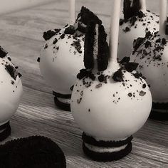 oreo cake pops with white frosting and black sprinkles on them