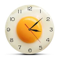 a clock with an egg in the middle of it's face on a white background