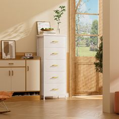 an empty room with a chair, dresser and door to the yard in front of it