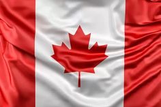 the flag of canada is shown in this closeup photo with silky folds and waves