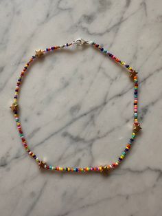 a multicolored beaded bracelet on a marble surface