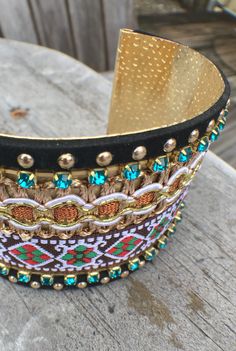 Head out and meet up with some friends for some java and listen to some indie music this weekend in this gypsy style cuff. This boho bracelet has a gold metallic interior with a mix of beads colorful crystals. The exterior features an elaborate embroidery detail surrounded by a trim of gold gems. Easy to get on and off, this bracelet is cool enough for a music festival and pretty enough for a date night - whatever suits your personal style. Only 1 left! Multicolored. One Size Fits All. Estimated Elaborate Embroidery, Metallic Interior, Colorful Crystals, Some Friends, Boho Bracelet, Indie Music, Boho Bracelets, Embroidery Details, Beaded Lace