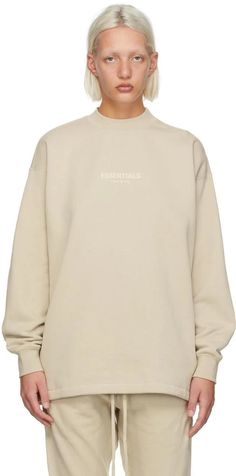 Fear of God ESSENTIALS.Beige Relaxed Crewneck Sweatshirt.Long sleeve cotton-blend fleece sweatshirt in beige. Logo flocked in off-white at front..· Rib knit crewneck collar, cuffs, and hem.· Rubberized logo patch at back collar.Please note that this item may not be shipped within the EU..Supplier color: Wheat.80% cotton, 20% polyester..Made in China..221161F098011 Beige Crewneck, Beige Sweatshirt, Crewneck Sweatshirt Women, Fear Of God Essentials, White Crewneck, Fear Of God, Women Essentials, Mens Essentials, Sweaters Crewneck