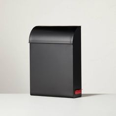 a black mailbox sitting on top of a white table