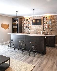 a bar with stools is in the middle of a living room