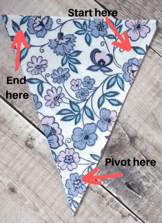 the instructions for how to tie a flowered necktie on a wooden surface with red arrows