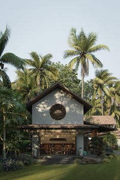 a small white building surrounded by palm trees