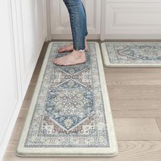 a person standing on top of two rugs