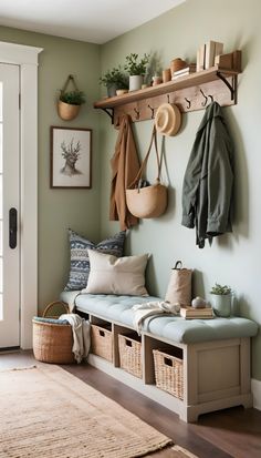 the entryway is clean and organized with baskets, coats, hats, and coat hooks