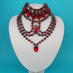 Our crystal jewellery collection is perfect for anyone who loves to accessorize with pieces that are both unique and stylish. Each Choker is made by hand to ensure the highest level of quality and artistry. The backing is coated in our trademark gunmetal coating. Colour - Red If there a colour you want, give us a message. We can do custom colourways if we have the crystals in stock. Handmade Gothic Body Jewelry For Party, Unique Party Choker Jewelry, Red Jeweled Bridal Necklace For Party, Victorian Metal Necklaces For Party, Victorian Metal Necklace For Party, Gothic Choker Jewelry For Party, Gothic Choker For Parties, Gothic Necklaces With Jewels For Party, Gothic Jewel Necklaces For Party