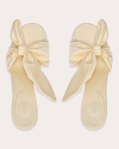 Dreamt up in lemon satin, the Diana sandal accentuates its curved edges with an asymmetric bow detail for dynamic dimension. Gently inset, the tapered kitten heel glides gracefully from dusk to dawn. Slip-on Asymmetric bow detail Satin upper Upper: 100% polyester Lining: 100% goat leather Heel: 100% ABS plastic Outsole: 100% cow leather Spot clean Handmade in Italy Size & Fit Heel height: 2.15in (55mm) Fits true to size Sustainability Metrics: Circular Economy: product is intentionally designed with 50% of actively cycled materials Organic Materials: at least 60% of materials used for production come from natural sources and do not contain harmful toxins or waste Craft & Community: at least 75% of products are fully sourced and manufactured within the specified community or country; 100% o Summer Sandals With Satin Bow And Open Heel, Spring Open Toe Sandals With Satin Bow, Chic Sandals With Satin Bow For Summer, Summer Sandals With Satin Bow, Flat Party Sandals With Bow, Summer Open Toe Heels With Satin Bow, Summer Evening Sandals With Bow, Chic Bow Sandals With Low Heels, Chic Low Heel Sandals With Bow