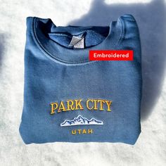 *SIZES ARE UNISEX* -I'd suggest your usual size for a more fitted look, or sizing up for a more relaxed fit. *these sweatshirts are extra comfy when oversized 🗻 "Park City Utah" with a mountain design embroidered on a comfy vintage-style crewneck. Perfect for any occasion or gift for him or her. A sturdy and warm sweatshirt bound to keep you warm in the colder months. A pre-shrunk, classic fit sweater that's made with air-jet spun yarn for a soft feel and reduced pilling. Your new favorite swea Fitted Crew Neck Sweater With Letter Print, Relaxed Fit Crew Sweater With Embroidered Logo, Casual Winter Sweater With Letter Embroidery, Fitted Crew Neck Casual Sweatshirt, Casual Fitted Crew Neck Sweatshirt, Winter College Tops With Embroidered Logo, Crew Sweatshirt With Embroidered Logo For Winter, Winter Crew Sweatshirt With Embroidered Logo, Winter Crew Neck Sweater With Letter Embroidery