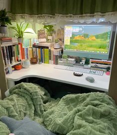 a desk with a computer and books on it in front of a book shelf filled with books