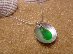 "Hand brushed sterling silver dome (1.5cm) within hangs a emerald green sea glass nugget . Linked to 18\"sterling silver snake chain. £34.00" Silver Sea Glass Round Pendant Jewelry, Silver Teardrop Sea Glass Jewelry, Main 1, Sea Glass Pendant, Silver Snake Chain, Green Sea, Snake Chain, Glass Pendant, Glass Pendants