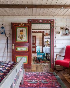 a room with a bed, chairs and paintings on the wall