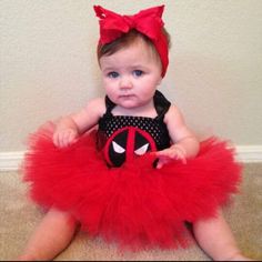 a baby girl wearing a red and black spiderman tutu