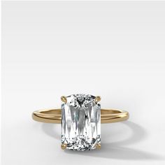 an emerald - cut diamond ring in yellow gold