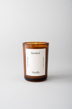 a candle that is sitting on top of a white surface with the words smoked written in it